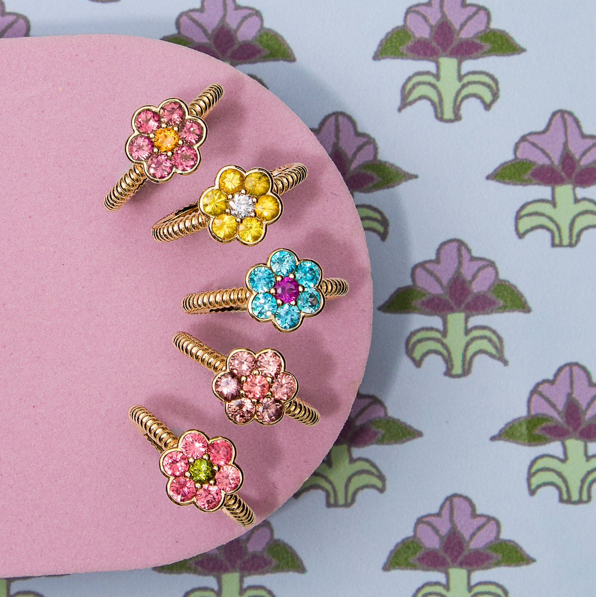 Five Blooms Medium Rings on pink - pink tourmaline and citrine, yellow sapphire and diamond, blue zircon and pink ruby, Tanzanian zircon and Mehenge spinel, Mehenge spinel and tourmaline