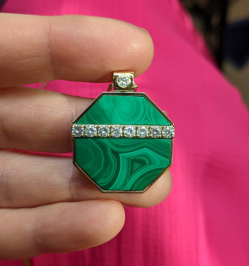 A hand cut malachite pendant using an antique stone jewelry box
