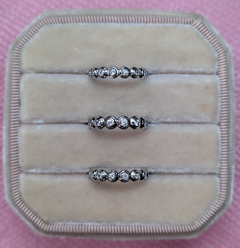 A set of platinum stacking bands combining diamonds from a series of heirloom pieces