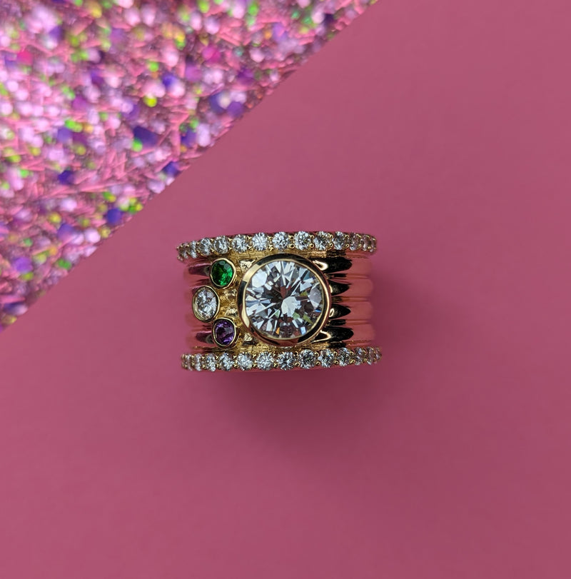 A cigar band ring using a family diamond & 3 birthstones to represent her children