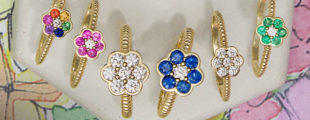 Blooms flower rings in rainbow, pink sapphire, diamond, blue sapphire and emerald in 14k yellow gold