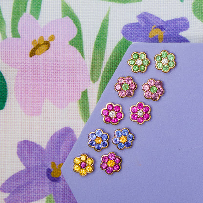 Five pairs of Blooms Stud Earrings on lilac - Merelani mint garnet and diamond, rhodolite garnet and Merelani mint garnet, pink ruby and diamond, tanzanite and spessartite garnet, yellow sapphire and grape garnet