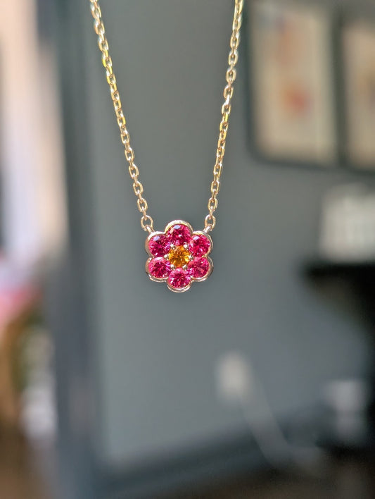 Small Blooms Pendant in Burmese spinel with spessartite garnet center, close-up on gold chain