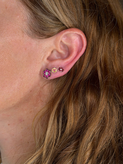 Blooms Stud Earring in pink ruby and diamond worn on the ear, stacked with Blooms Mini Studs