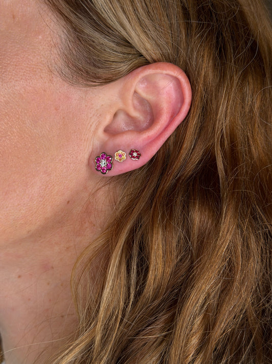 Blooms Stud Earring in pink ruby and diamond worn on the ear, stacked with Blooms Mini Studs