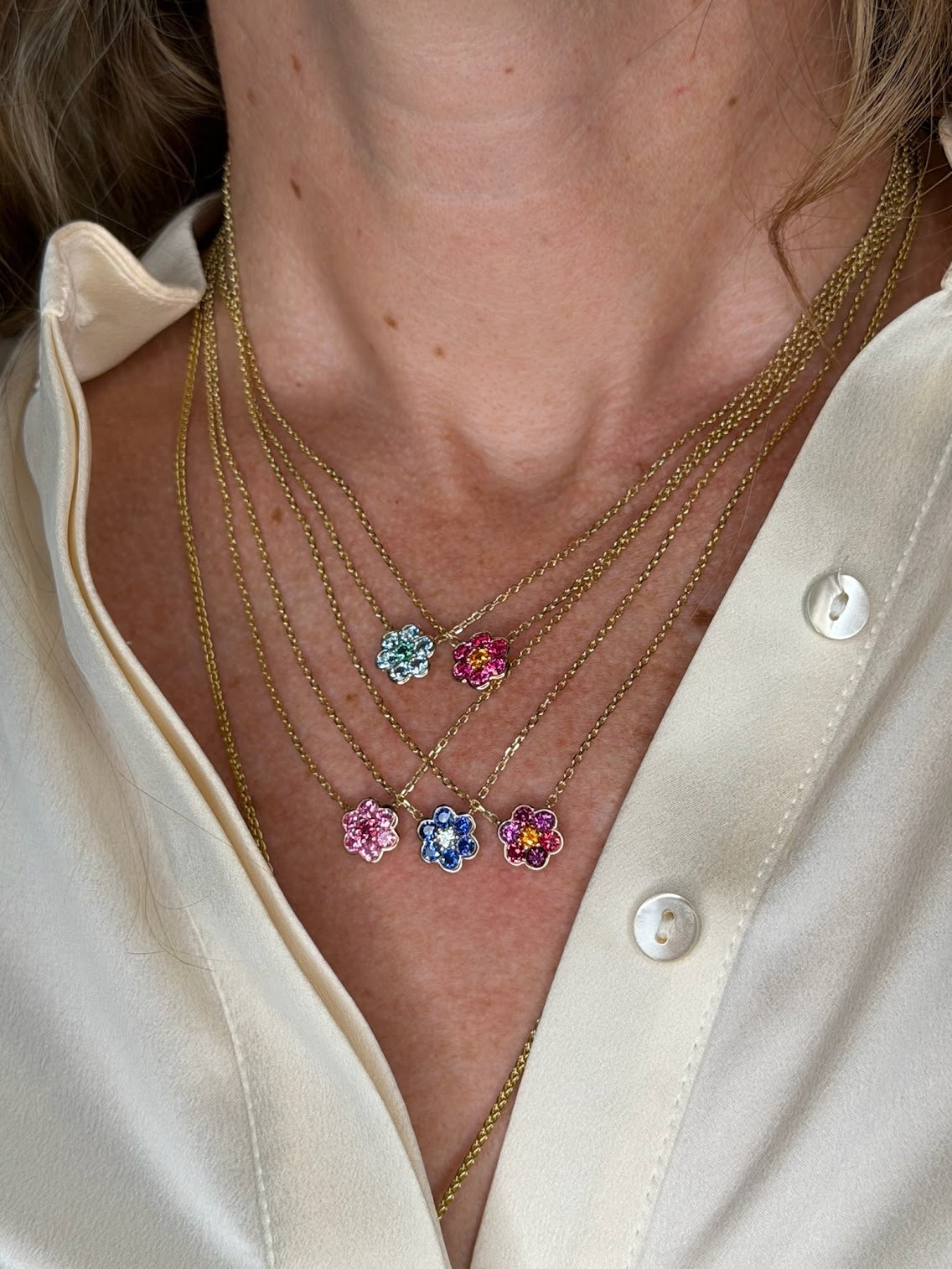 Five Small Blooms Pendants close-up - aquamarine, Burmese spinel, pink sapphire, blue sapphire and diamond, Burmese spinel with plum and spessartite garnet