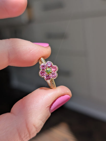 Blooms Medium Ring in Mehenge spinel and tourmaline, close-up held in hand