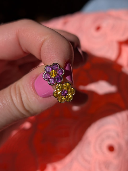 Blooms Stud Earrings in yellow sapphire and grape garnet, opposite flowers, pair held in hand