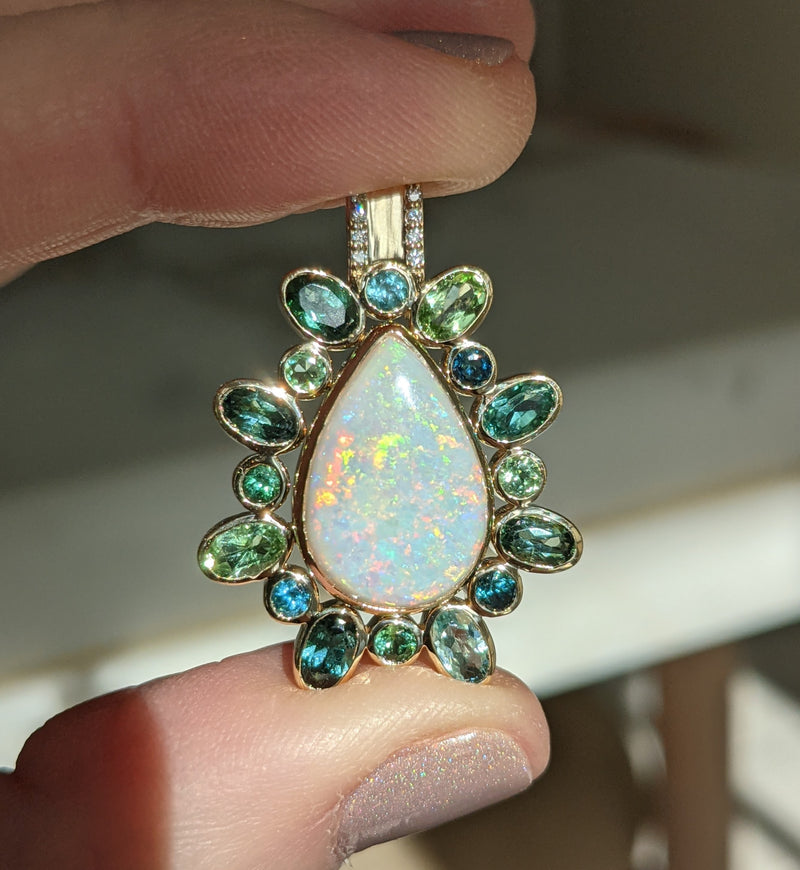 An heirloom opal transformed with a halo of green & blue tourmalines