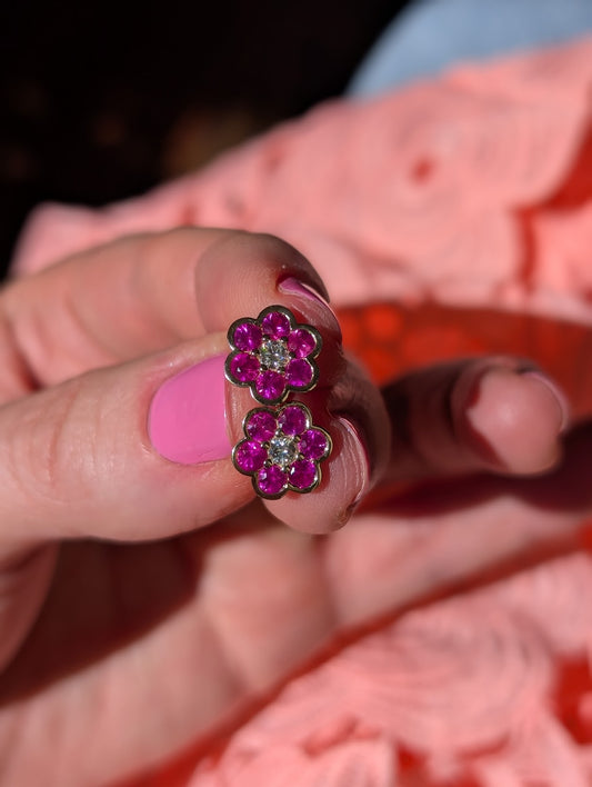 Blooms Stud Earrings in pink ruby with diamond center, pair held in hand