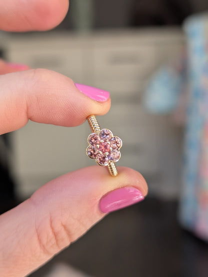 Blooms Medium Ring in Tanzanian zircon and Mehenge spinel, close-up held in hand