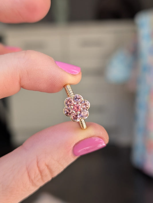 Blooms Medium Ring in Tanzanian zircon and Mehenge spinel, close-up held in hand