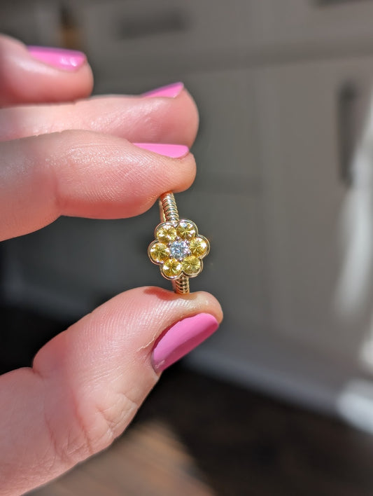 Blooms Medium Ring in yellow sapphire and diamond, close-up held in hand