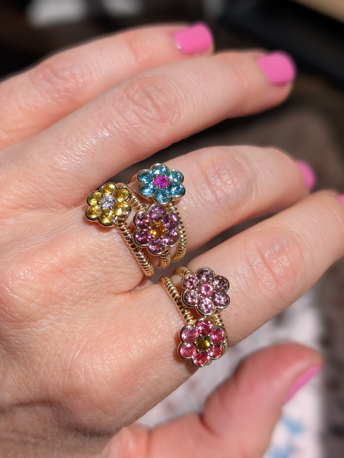 Blooms Medium Rings stacked on the hand - yellow sapphire and diamond, blue zircon and pink ruby, pink tourmaline and citrine, Tanzanian zircon and Mehenge spinel, Mehenge spinel and tourmaline