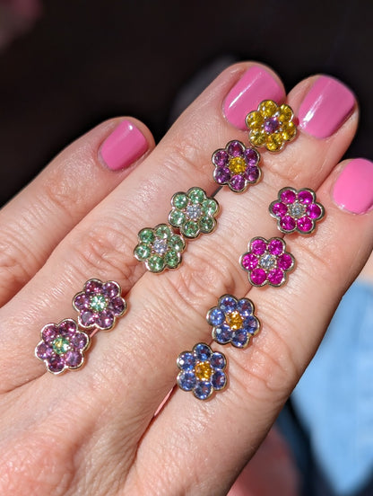 Blooms Stud Earrings close-up in hand - yellow sapphire and grape garnet, rhodolite garnet and Merelani mint garnet, tanzanite and spessartite garnet, pink ruby and diamond