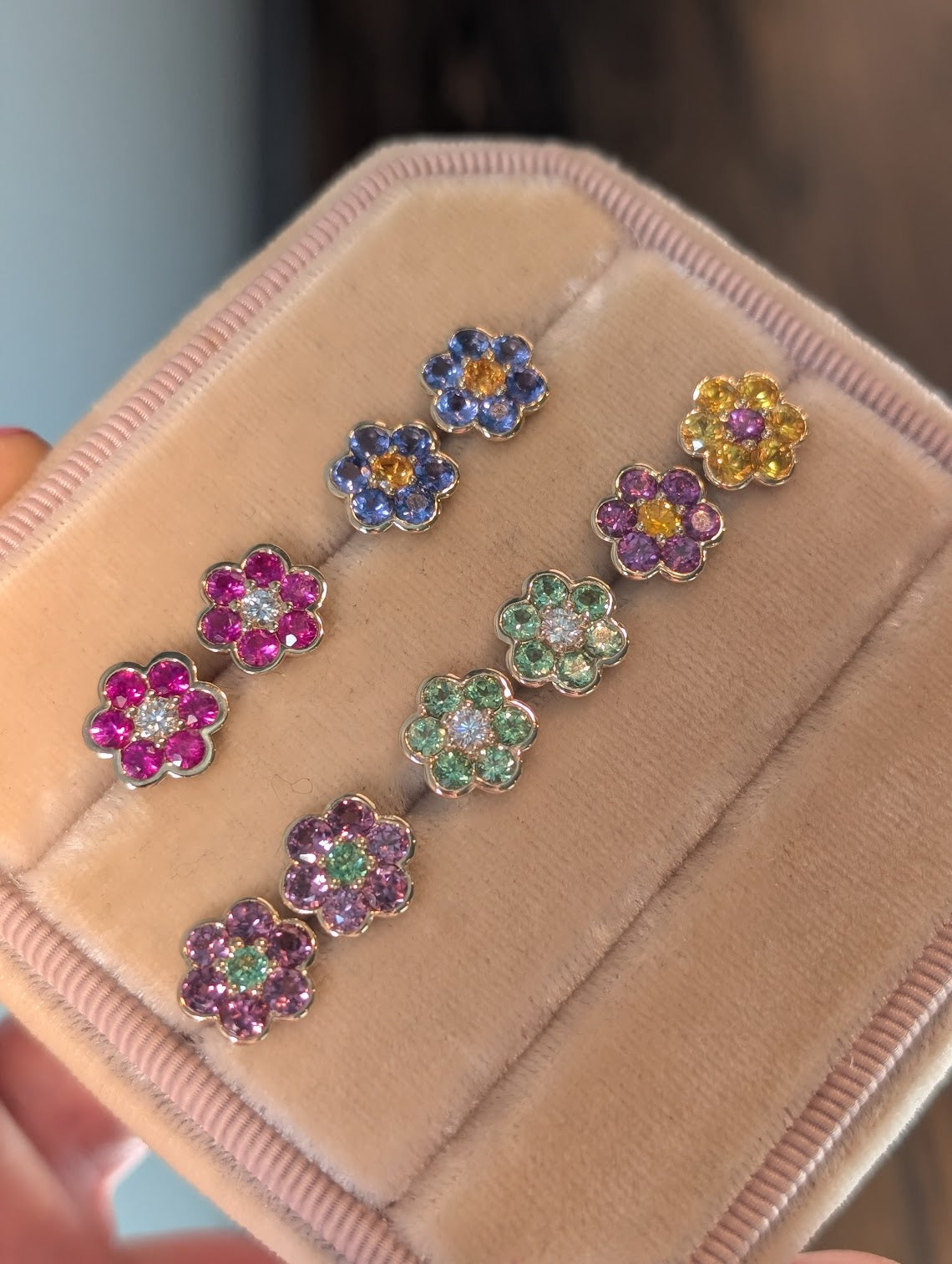 Blooms Stud Earrings in a velvet jewelry box, angled close-up of all five pairs