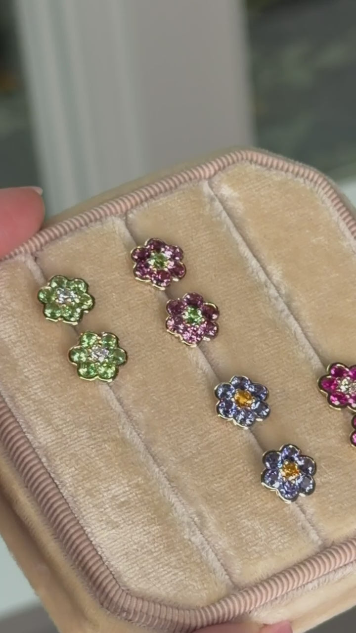 Video of Blooms Stud Earrings in a velvet jewelry box - Merelani mint garnet and diamond, rhodolite garnet and Merelani mint garnet, tanzanite and spessartite garnet, pink ruby and diamond