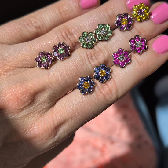 Video of five pairs of Blooms Stud Earrings held in hand in sunlight
