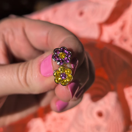 Video of the Blooms Stud Earrings in yellow sapphire and grape garnet held in sunlight
