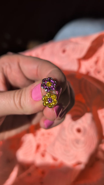 Video of the Blooms Stud Earrings in yellow sapphire and grape garnet held in sunlight