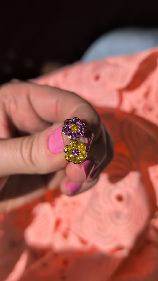 Video of the Blooms Stud Earrings in yellow sapphire and grape garnet held in sunlight