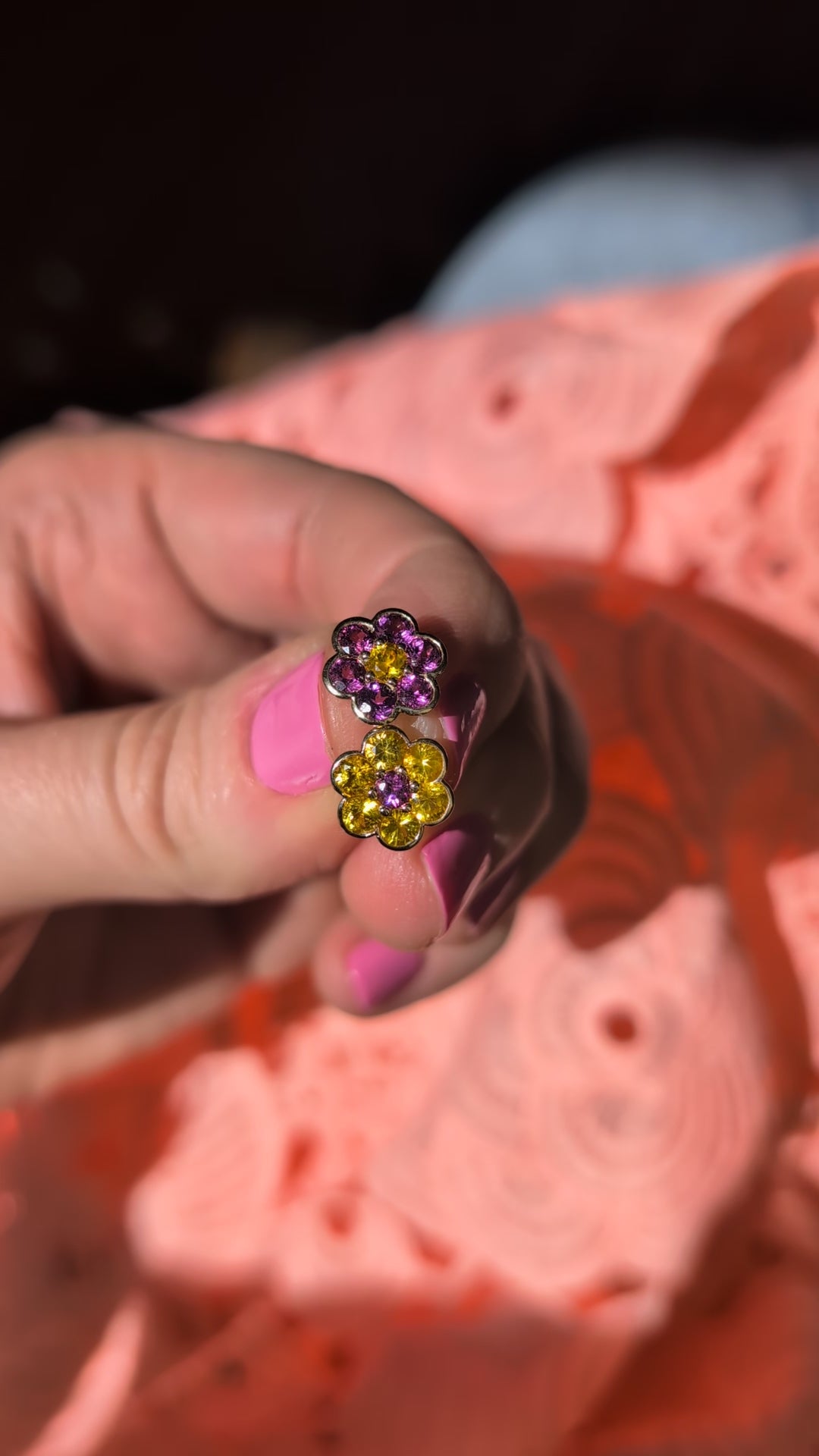 Video of the Blooms Stud Earrings in yellow sapphire and grape garnet held in sunlight