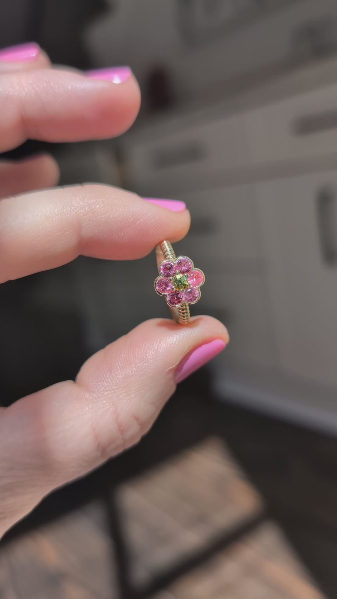 Video of the Blooms Medium Ring in Mehenge spinel and tourmaline held in sunlight