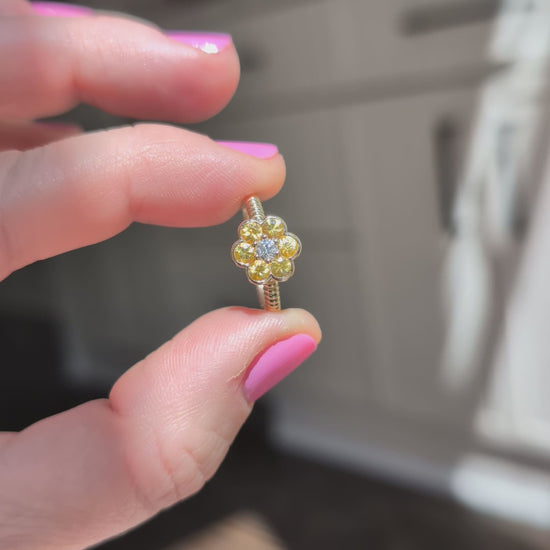 Video of the Blooms Medium Ring in yellow sapphire and diamond held in sunlight