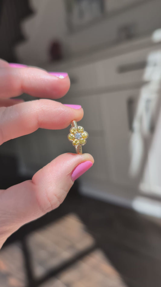Video of the Blooms Medium Ring in yellow sapphire and diamond held in sunlight