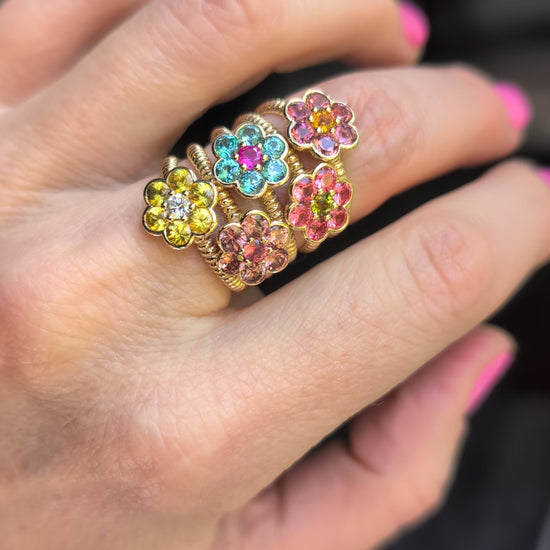 Video of five Blooms Medium Rings stacked on the hand - yellow sapphire and diamond, blue zircon and pink ruby, Tanzanian zircon and Mehenge spinel, pink tourmaline and citrine, Mehenge spinel and tourmaline
