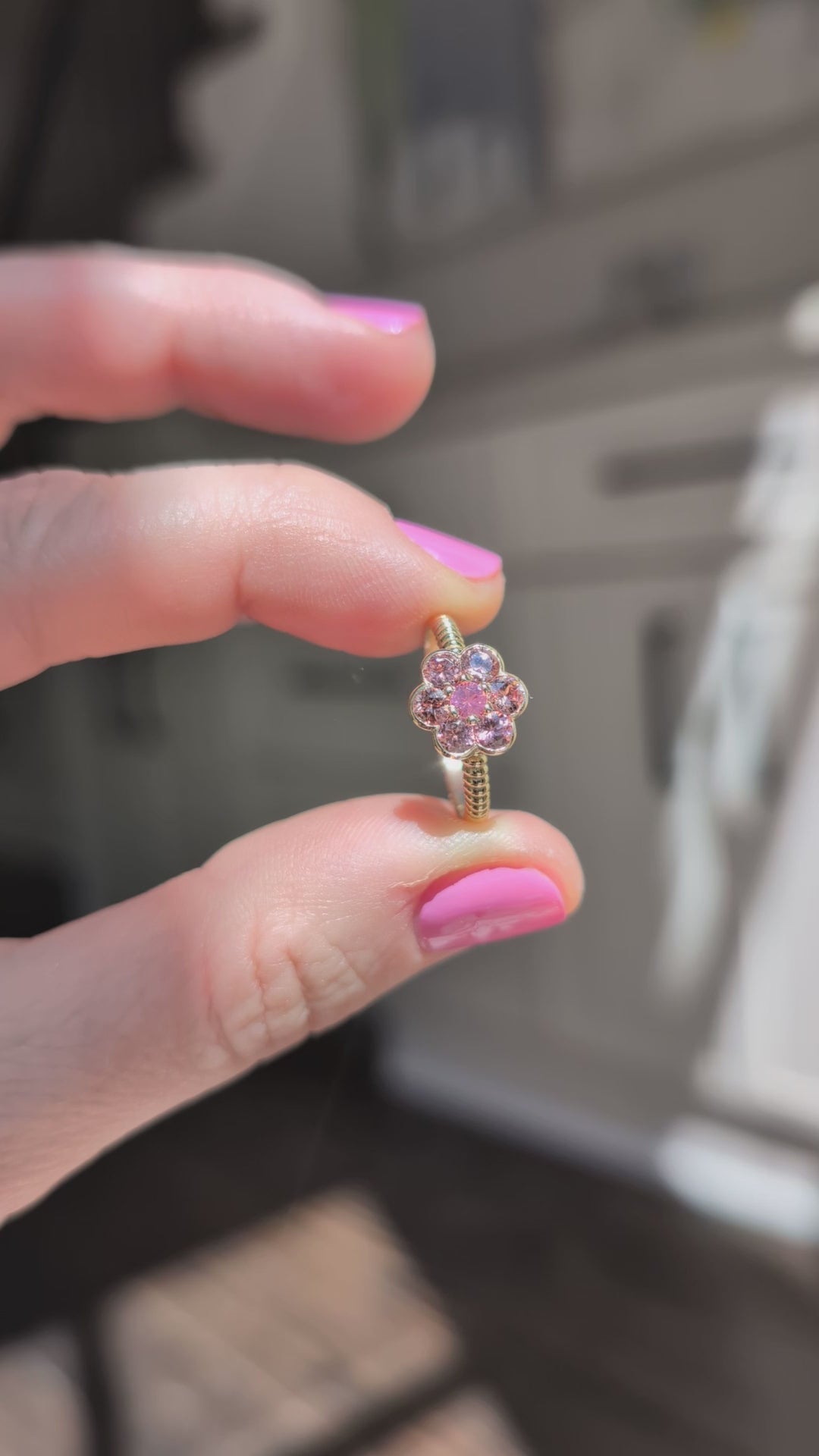 Video of the Blooms Medium Ring in Tanzanian zircon and Mehenge spinel held in sunlight