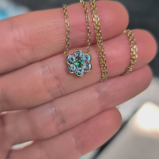 Video of the Small Blooms Pendant in aquamarine and tourmaline held in the palm