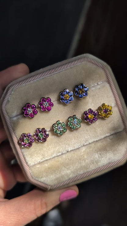 Video of five pairs of Blooms Stud Earrings in a velvet jewelry box in sunlight
